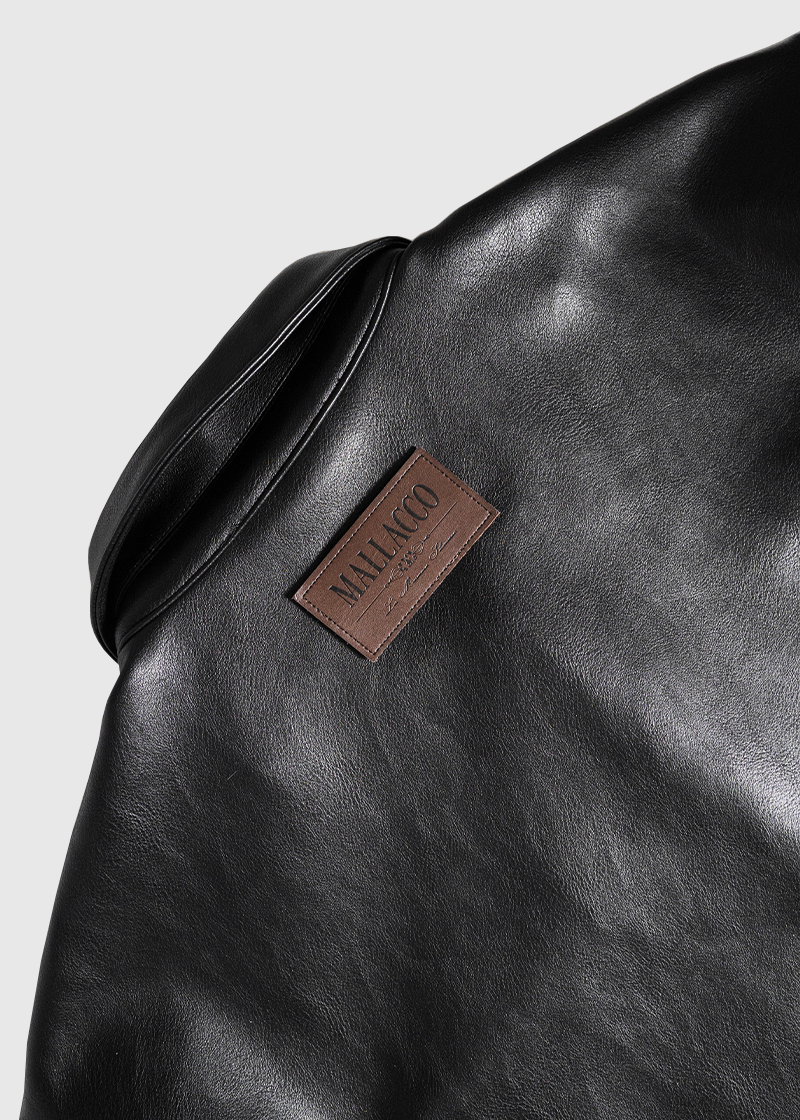 Close-up of Mallacco vegan leather shirt collar and label details