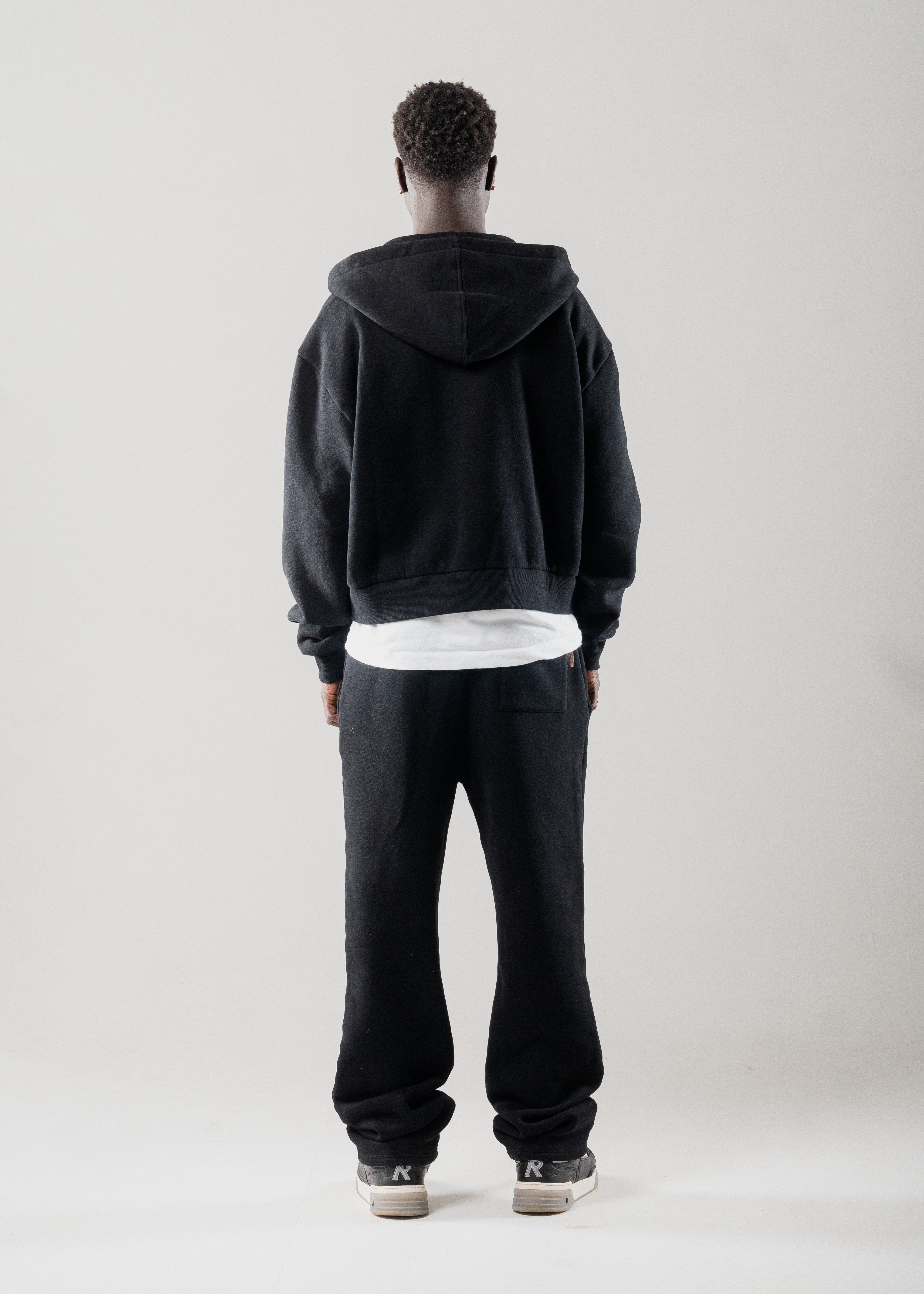 Model layering Mallacco black double zip hoodie under outerwear