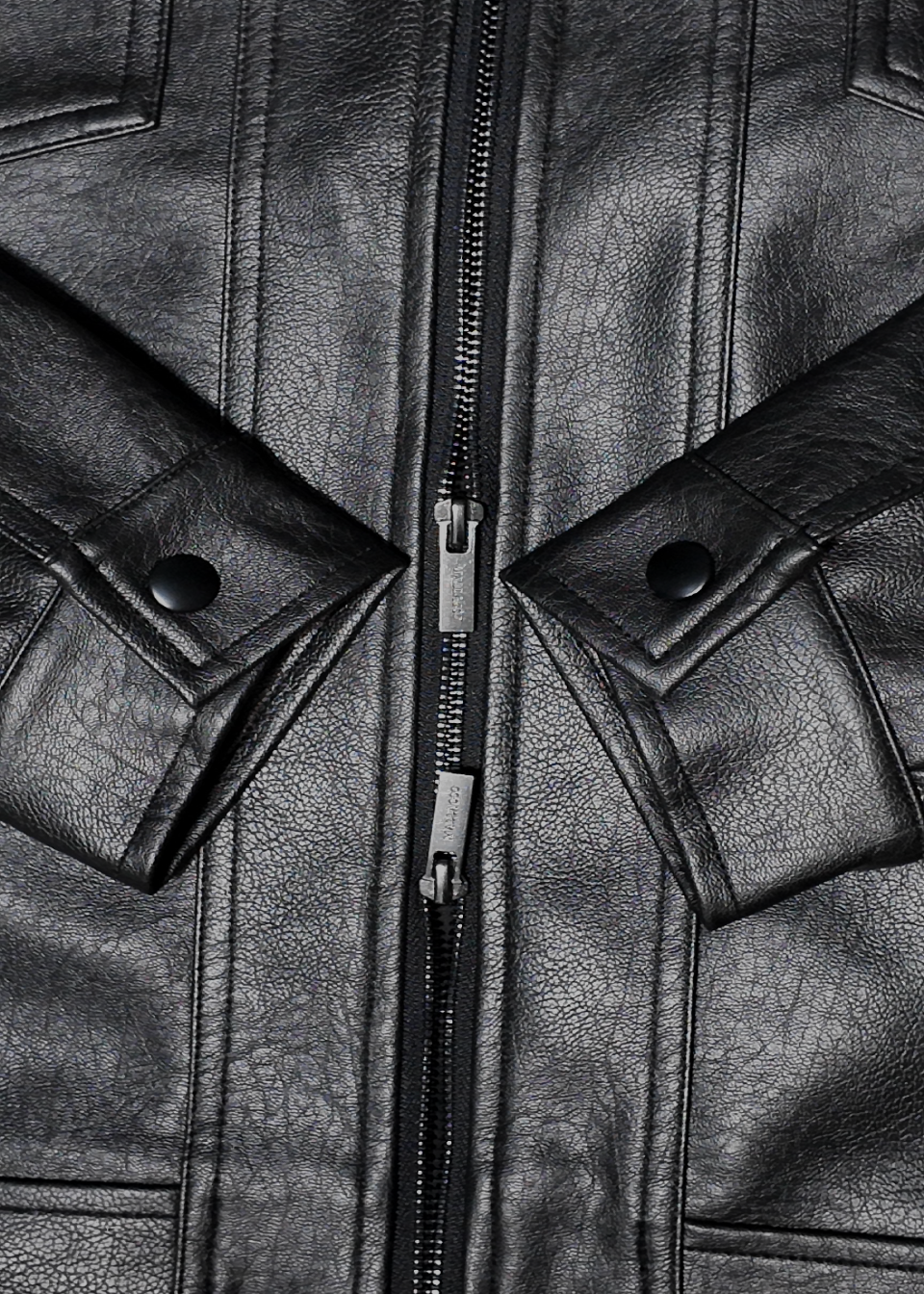 Close-up of a black leather jacket with a zipper