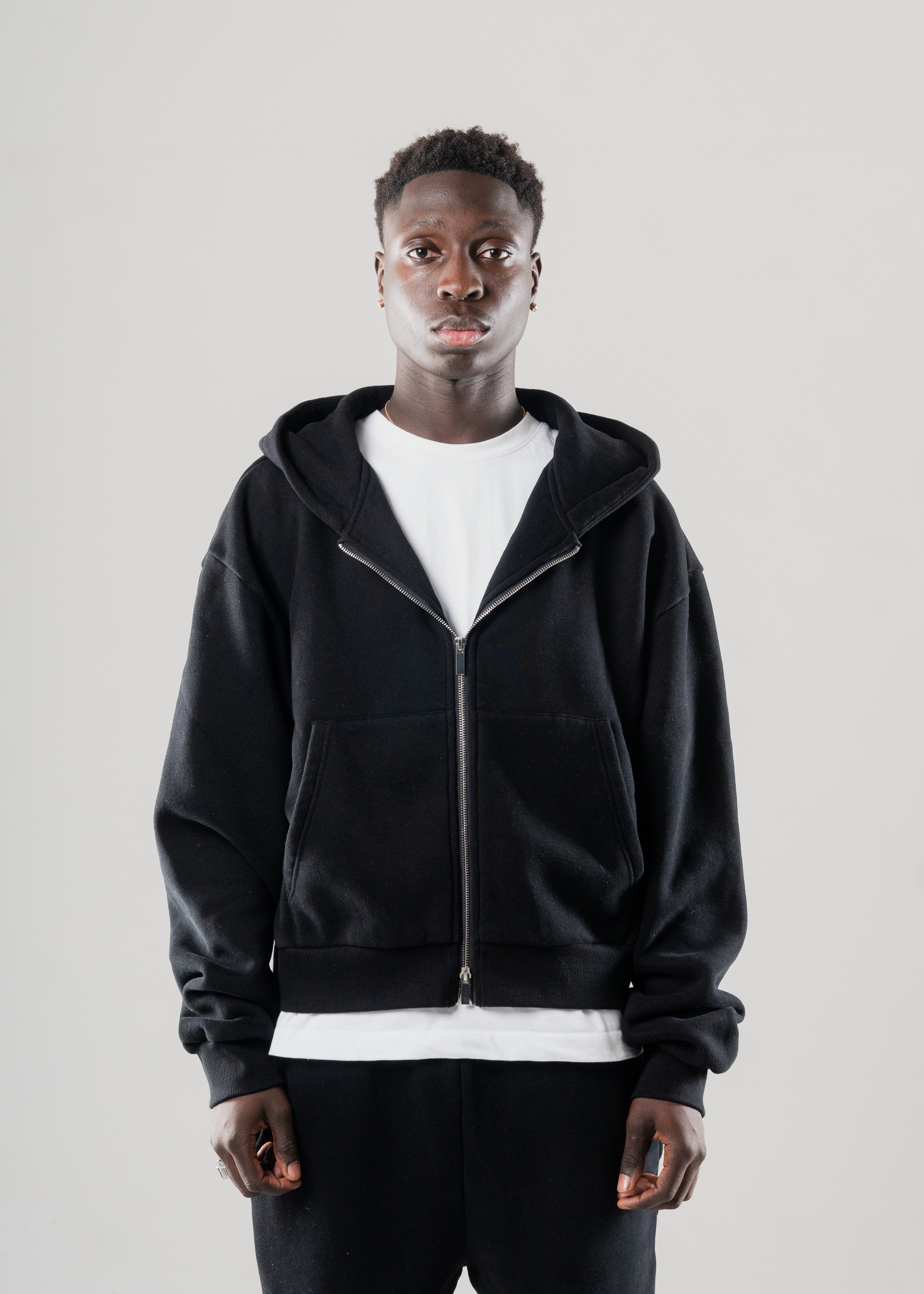 Front view of Mallacco men’s black hoodie featuring dual zipper design