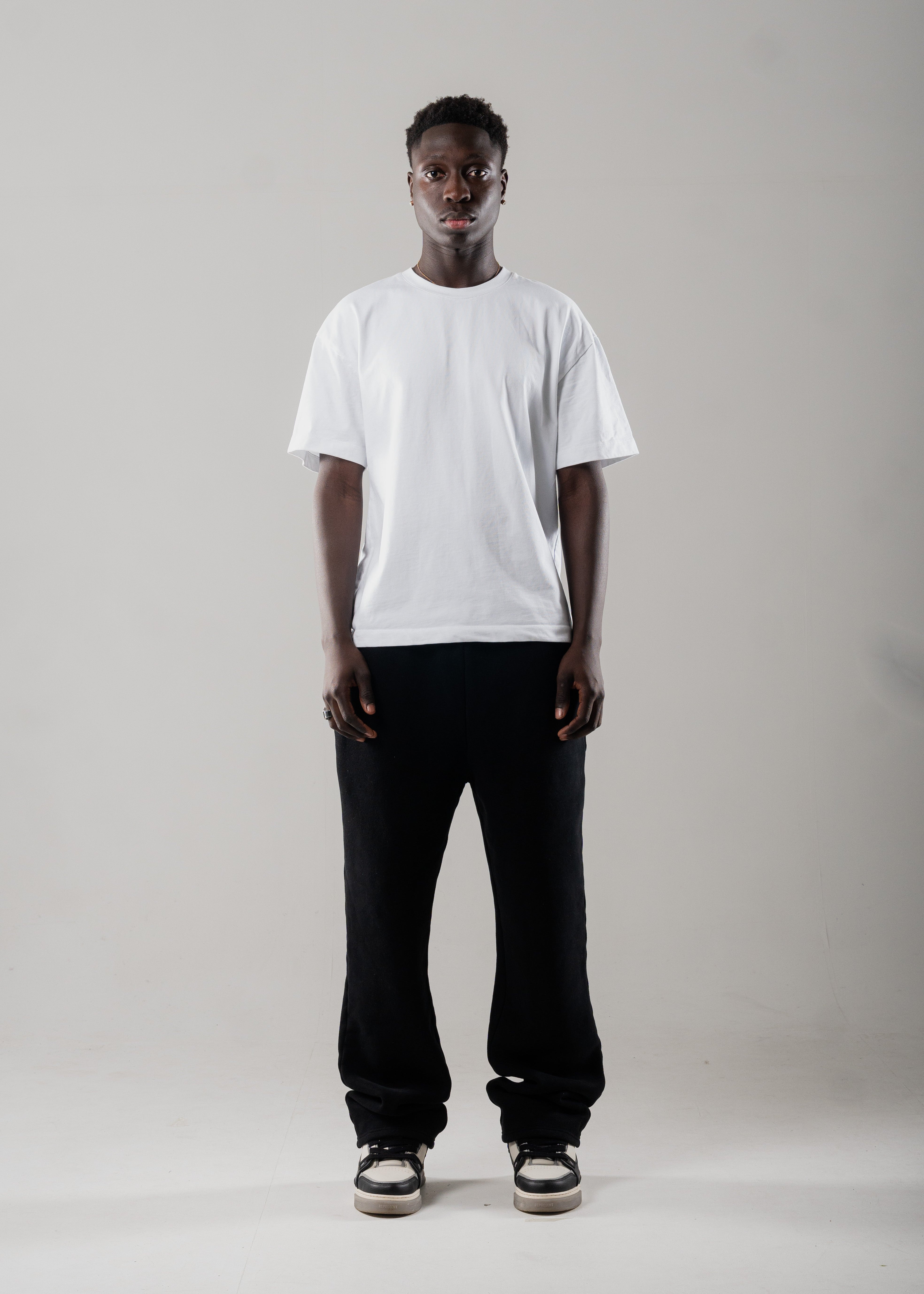 Model wearing Mallacco black straight leg jogger styled with minimal outerwear.