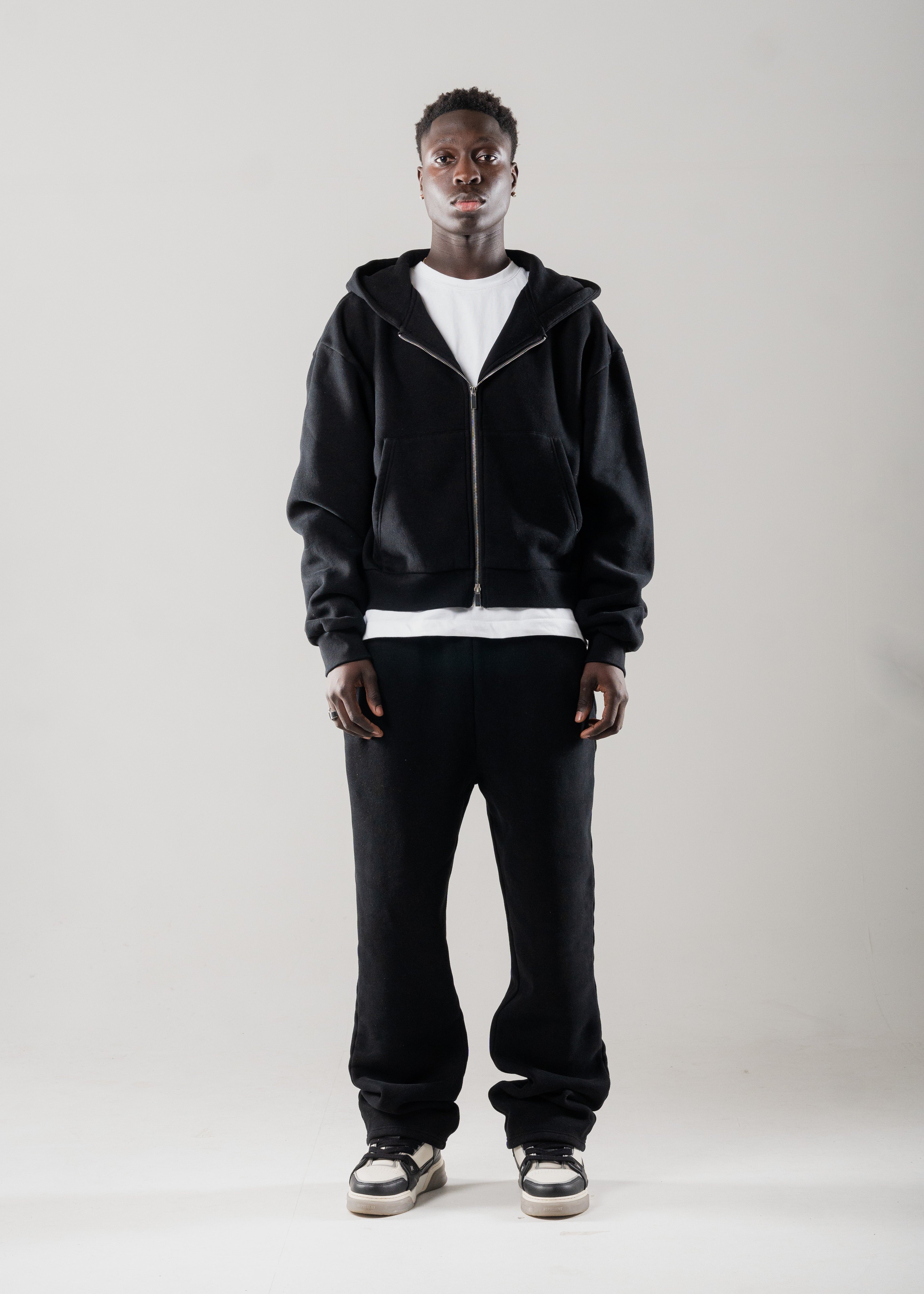 Model layering Mallacco black double zip hoodie under outerwear