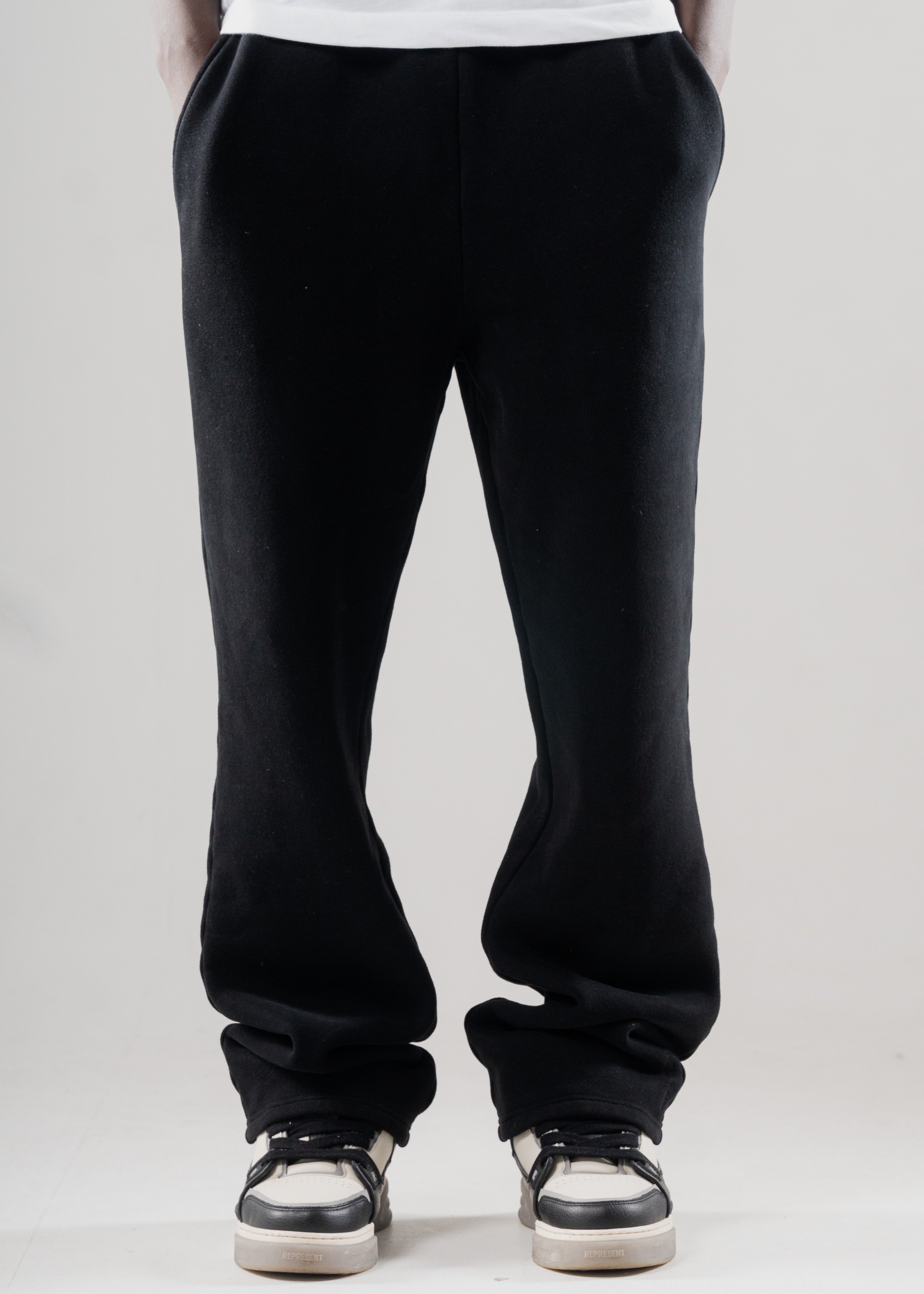 Model wearing Mallacco black straight leg jogger styled with minimal outerwear.